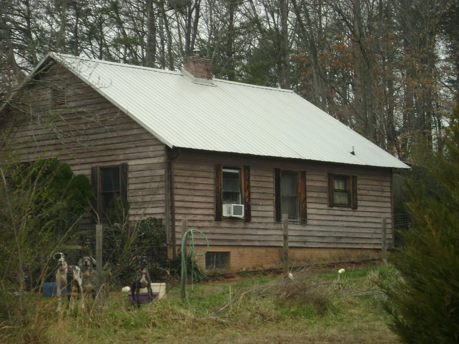 White metal roof on an old wood sided farmhouse, from a Metal Roof Installation job in Kemmerer